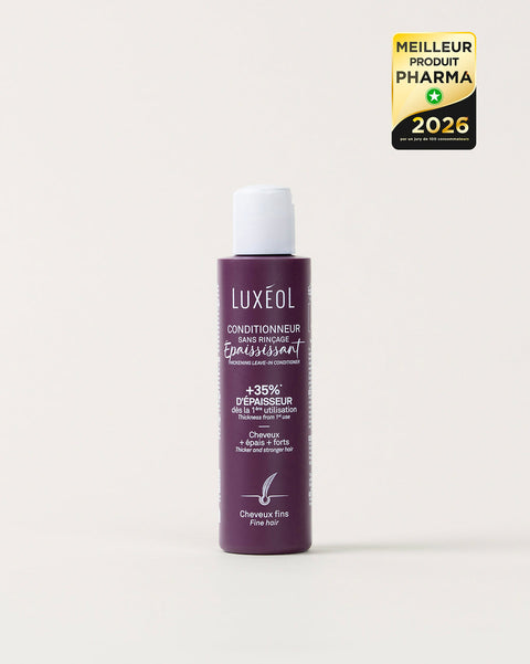 Violetinis Luxéol plaukų priemonės buteliukas baltame fone su auksiniu ir juodu apdovanojimo ženkleliu.
