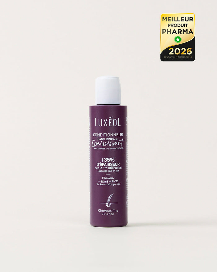 Violetinis Luxéol plaukų priemonės buteliukas baltame fone su auksiniu ir juodu apdovanojimo ženkleliu.